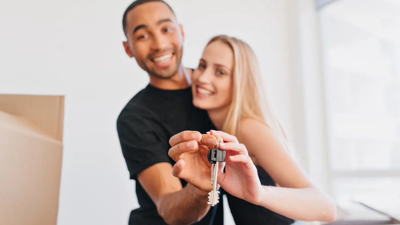 A couple holding the keys to their new house